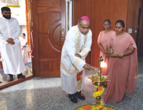 Archbishop Rev. John Rodrigues lighting a ceremonial lamp at the Sarita hostel inauguration