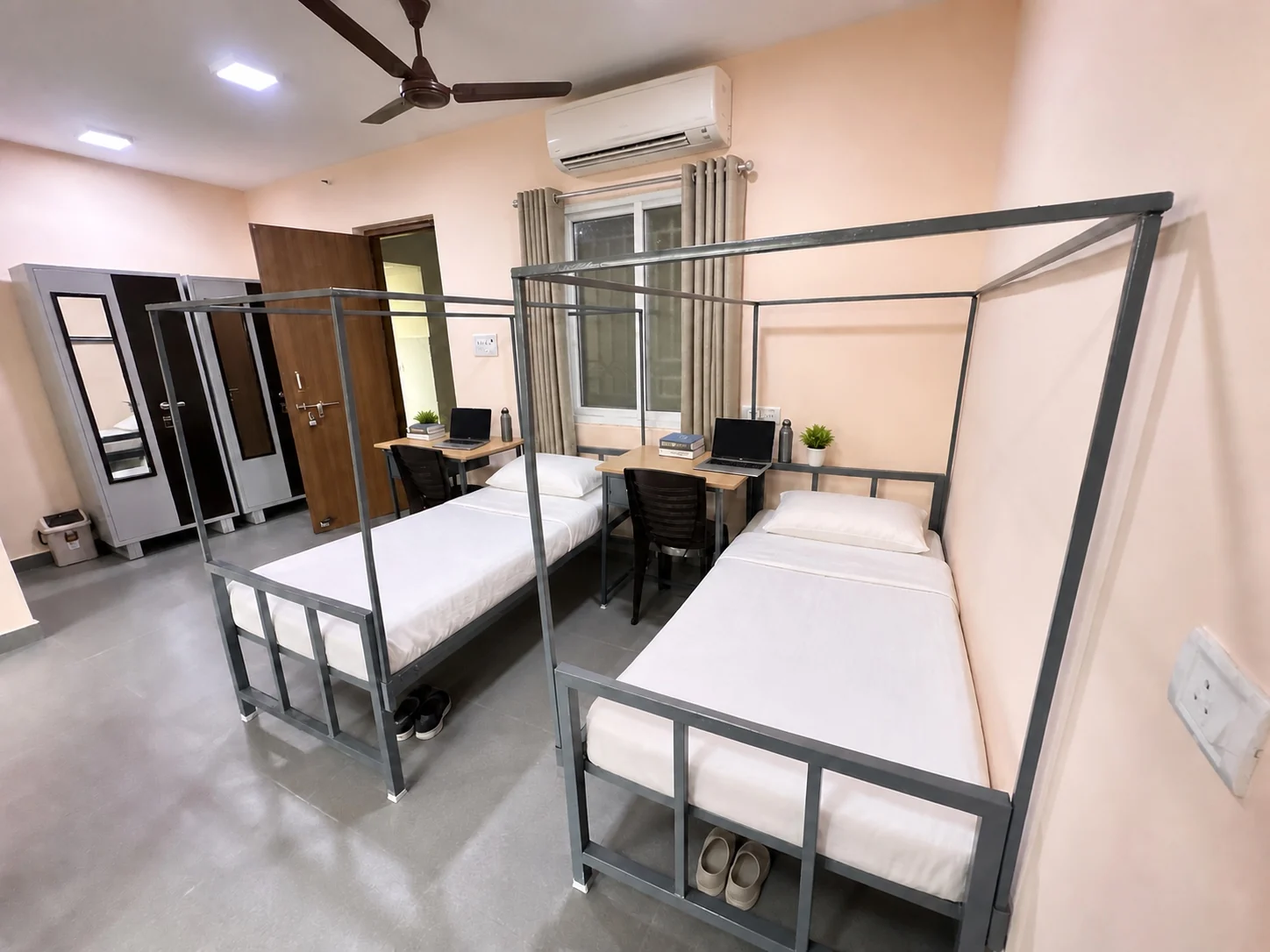 Double sharing room with two beds, desks and wardrobes