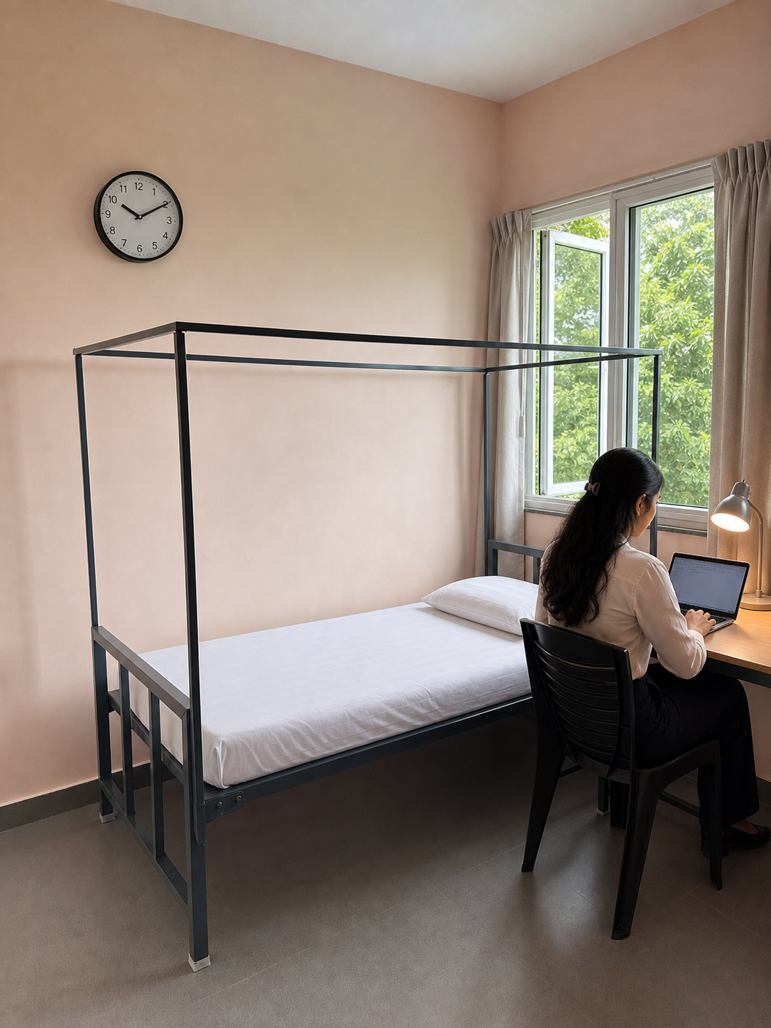 A working woman using her laptop in a double-sharing room at Sarita
