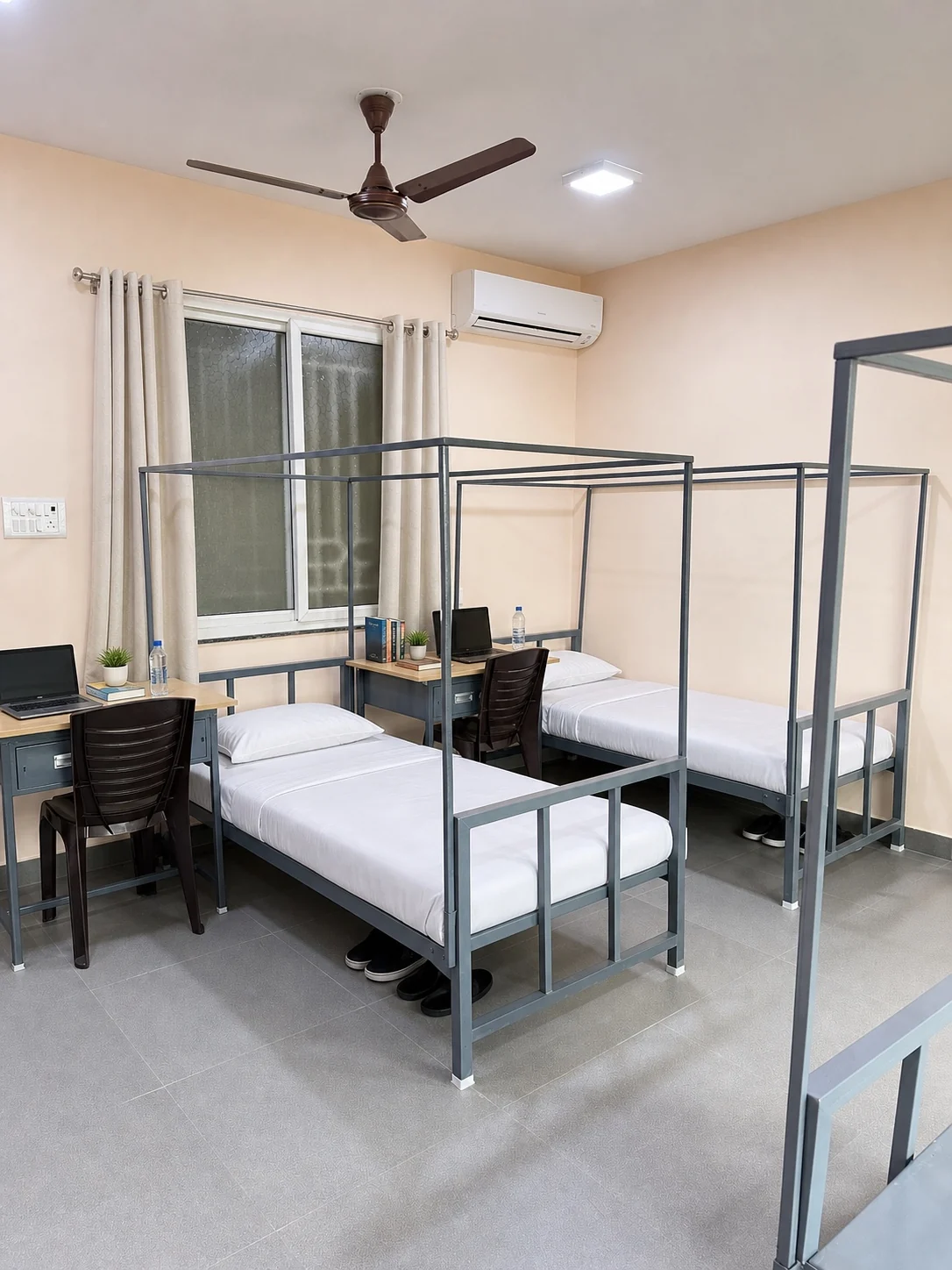 Triple sharing room with beds and individual desks