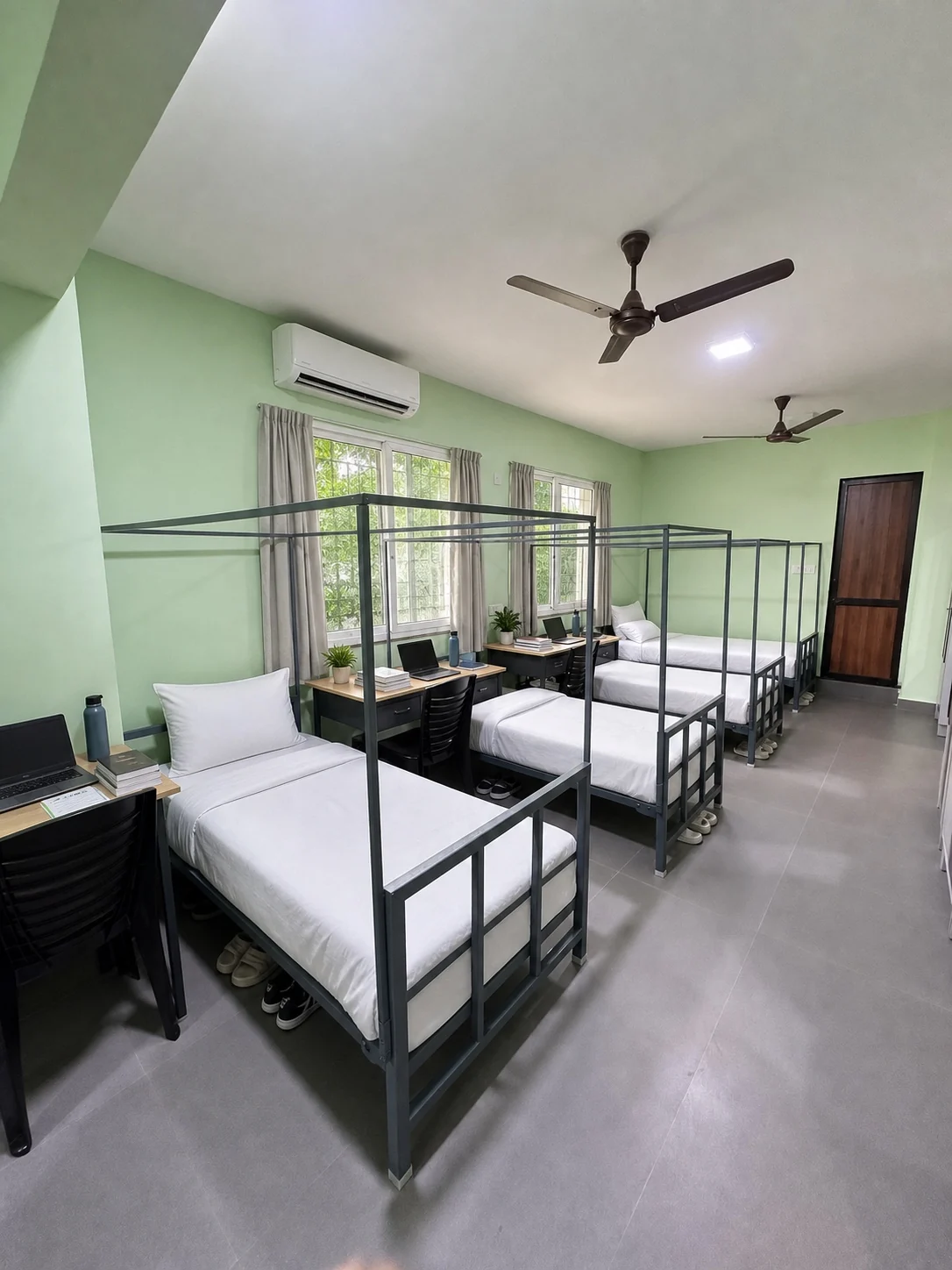 Dormitory room with multiple beds and desks