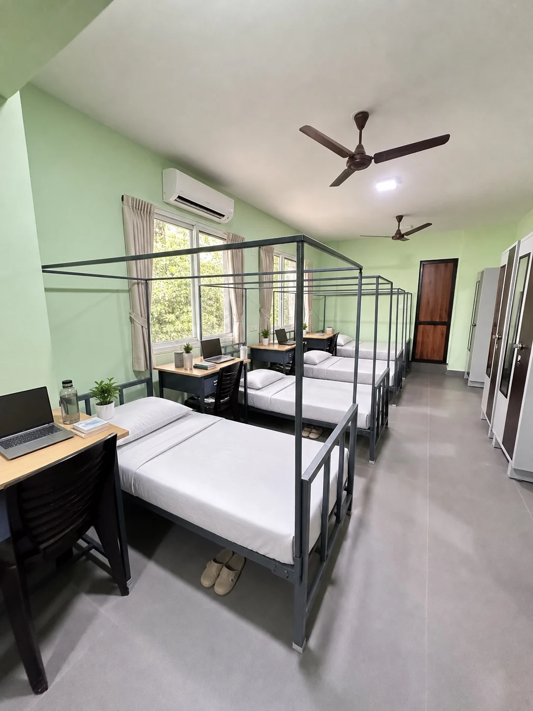 Dormitory beds beside individual study spaces