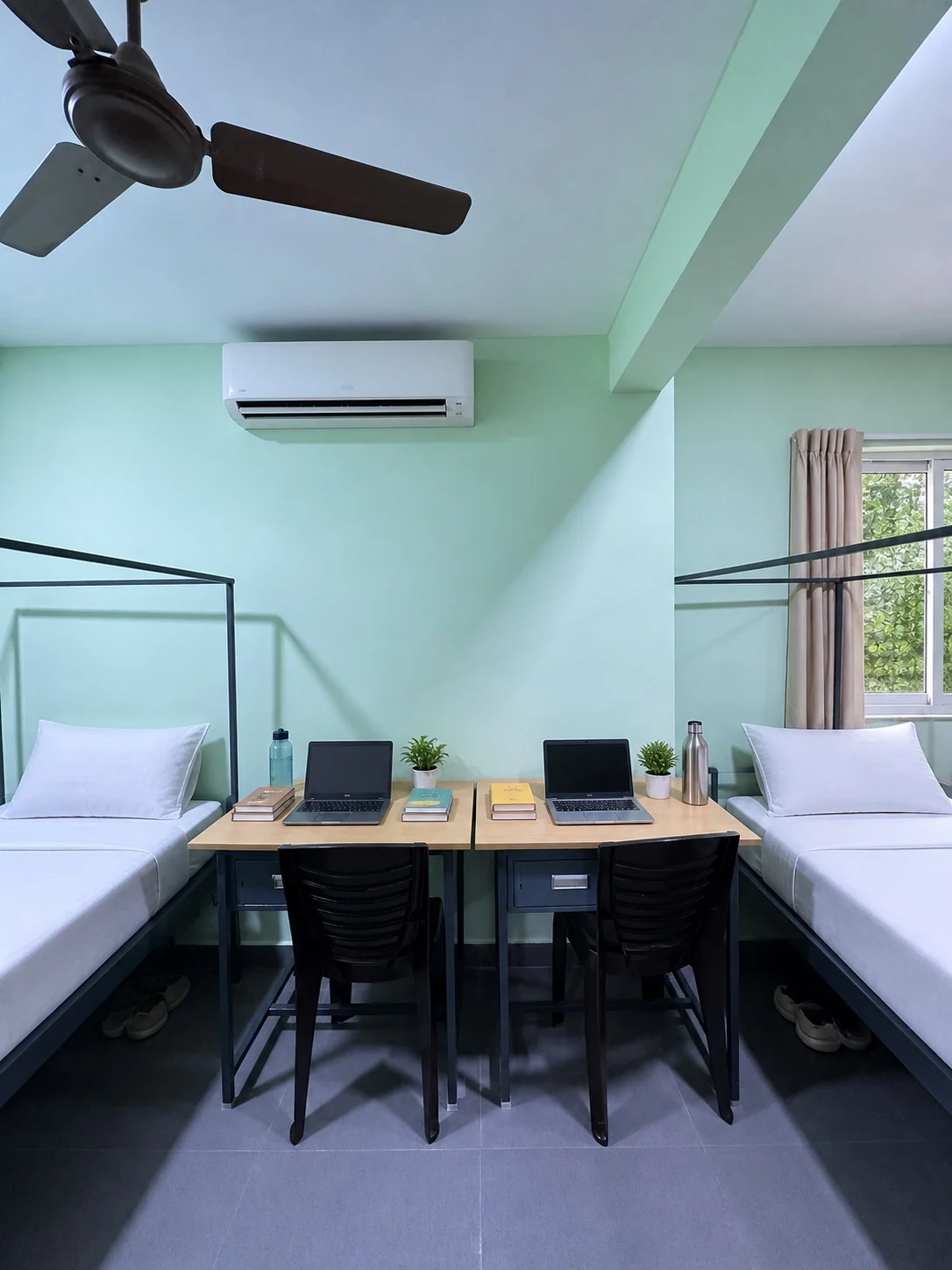 Dormitory study desks between furnished beds