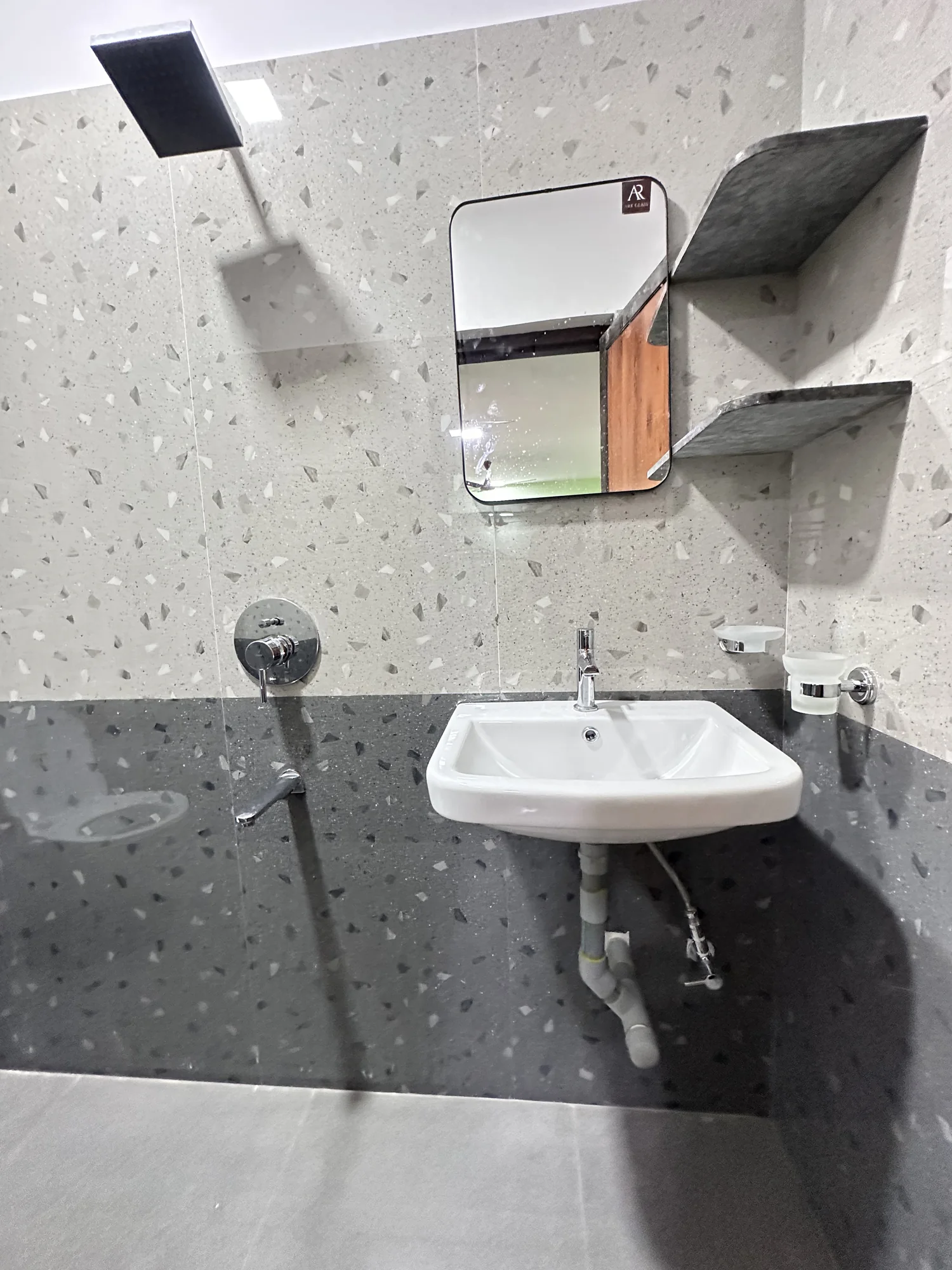 Washbasin and mirror in a shared bathroom