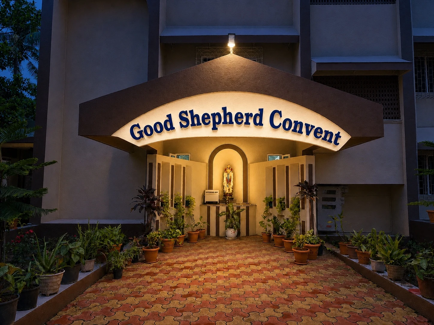 Good Shepherd Convent entrance and grotto chapel illuminated at night